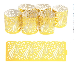 Detailed laser-cut gold leaf pattern decorative wraps for tea light candles and cupcakes