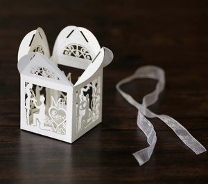 White laser-cut wedding favor box featuring Mr & Mrs silhouettes and Love lettering