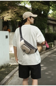 Detail of beige and black nylon crossbody chest bag with adjustable strap and drawstring