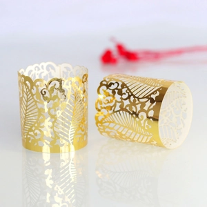Detail of golden laser-cut hollow pattern for cupcakes and LED candles decoration