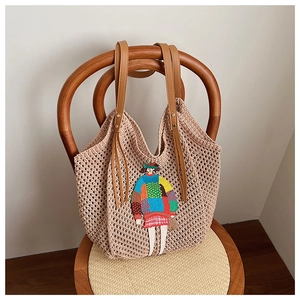Detailed macro view of the colorful cartoon embroidery on a beige crochet tote bag