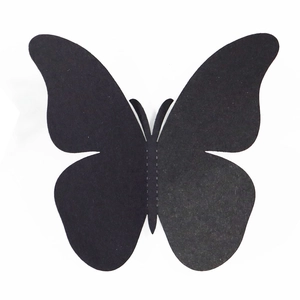 Détail d'un autocollant mural papillon 3D noir avec ligne de pliage et texture mate