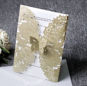 Detail of glitter gold laser-cut butterfly invitation with 40th birthday insert card