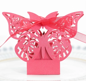 Detailed laser-cut butterfly wedding favor box in rose red with matching silk ribbon bow