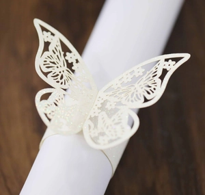 Detalle de servilletero de mariposa cortado con láser con acabado brillante y flores