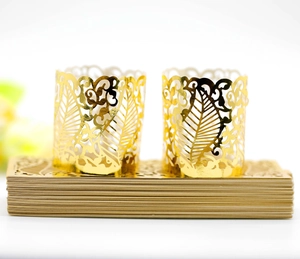 Detail of laser-cut gold lace decorative wraps for LED candles and party cake decor