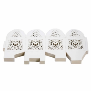 Laser-cut white heart-shaped wedding favor boxes shown stacked in flat unassembled state