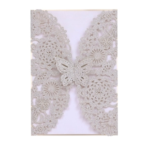 Close-up of laser-cut rose hollow invitation with silver glitter finish and butterfly