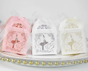 Detailed laser cut wedding favor boxes with bride and groom silhouette and ribbon