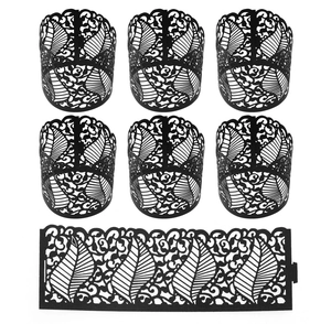 Elegant black laser-cut paper votive candle holders with intricate leaf pattern designs