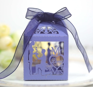 Detail of purple laser-cut wedding candy box with Mr & Mrs silhouette and ribbon
