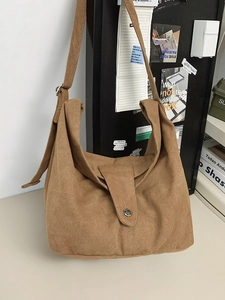 Minimalist deep khaki canvas crossbody tote bag with wide strap and vintage button detail