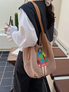 Chic knit tote bag featuring cartoon embroidery and brown leather straps for daily commute