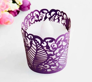 Close-up of laser-cut purple paper sleeve with floral pattern for LED tea lights
