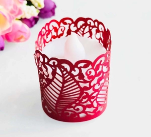 Detailed laser-cut red paper wrap featuring intricate leaf patterns for LED tea light candles