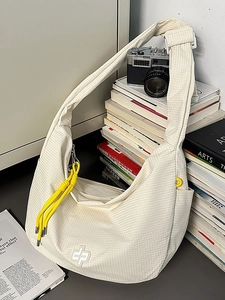 Beige plaid crossbody dumpling bag with yellow cord detail and large storage capacity