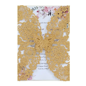 Laser-cut glittery gold wedding invitation featuring intricate floral and butterfly patterns