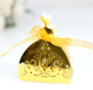 Detailed laser-cut gold wedding favor box in bridal gown shape with yellow ribbon bow
