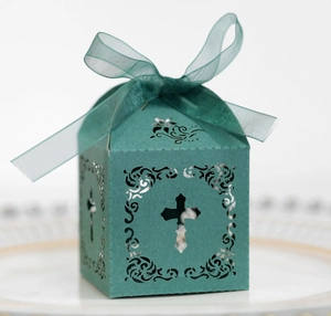 Détail de la boîte cadeau émeraude avec croix ajourée et ruban en organza chic