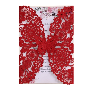 Laser cut red glitter wedding invitation with intricate butterfly and floral lace design