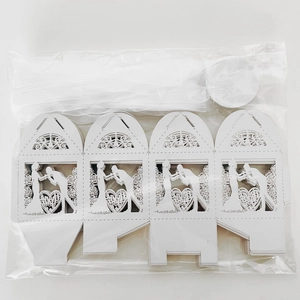 Detailed laser-cut wedding favor box with bride and groom silhouettes and ribbon