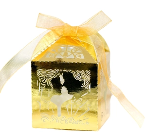 Golden laser-cut wedding favor box with bride and groom silhouette and organza ribbon bow