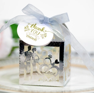 Detailed close-up of a silver mirror wedding gift box with laser-cut bride and groom silhouette