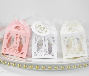 Laser-cut wedding favor boxes with bride and groom silhouette and sheer ribbons