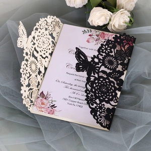Detail of laser-cut butterfly lace invitation with elegant pink rose inner card