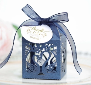 Detailed laser-cut hollow swan gift box in dark blue with satin ribbon and thank you tag