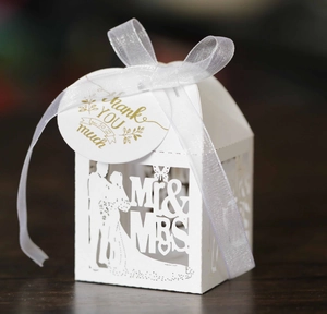 Detail of laser cut white wedding favors box with MR & MRS silhouette and Thank You tag