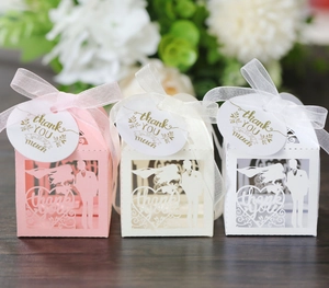 Detailed laser-cut hollow wedding favor boxes with groom and bride silhouette and ribbons