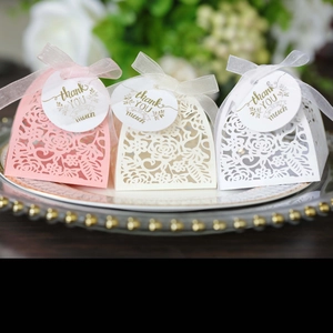 Detailed laser-cut rose gift boxes in pink and white with ribbons and thank you tags