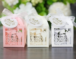 Detailed laser cut favor boxes with bride and groom silhouettes and chiffon ribbons