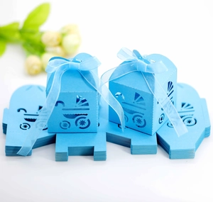 Detail of light blue baby stroller laser cut gift box with ribbon for party favors