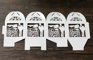 Detailed laser-cut wedding favor box featuring groom bride silhouettes and thank you text