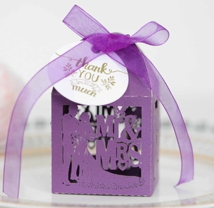 Detail of purple laser-cut wedding favor box with Mr & Mrs design and Thank You tag