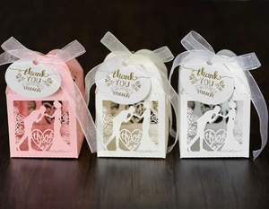 Detail view of laser-cut rose gift boxes with ribbons and thank you tags in three colors