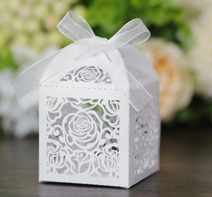 Detail of white laser-cut rose gift box with elegant organza ribbon for weddings