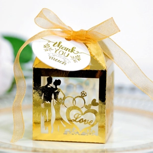 Golden laser-cut wedding favor box with Love silhouette and Thank You hanging tag