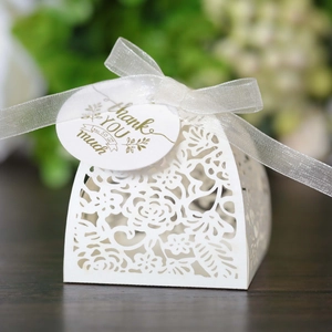 Detailed laser-cut white wedding favor box with rose patterns and Thank You tag