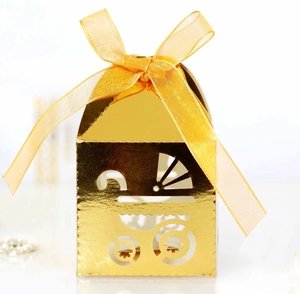 Close-up of golden hollow baby stroller gift box with a yellow ribbon bow decoration