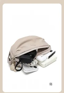 Detail of canvas saddle bag with dual zipper compartments showing large interior capacity