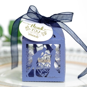 Purple laser-cut wedding favor box with romantic silhouette, navy ribbon, and thank you tag