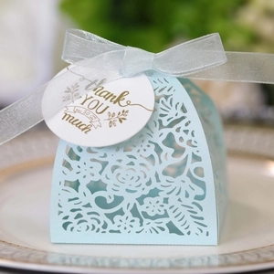 Detailed laser-cut light blue wedding candy box with elegant ribbon and thank you tag