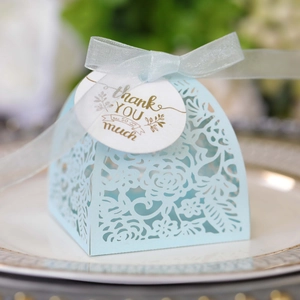 Laser-cut light blue wedding favor box with ribbon and gold foil thank you tag