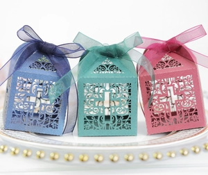 Detailed laser-cut candy boxes with floral hollow patterns and matching organza ribbons