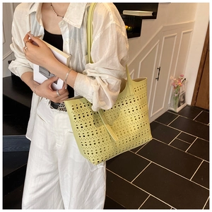 Sac cabas ajouré vert clair avec motifs géométriques au laser porté par un mannequin