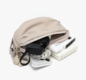 Internal view of the crescent nylon bag showing storage space for phone and umbrella