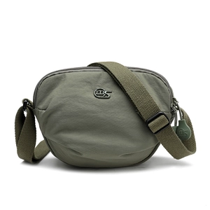 Detail view of the green nylon saddle bag featuring a metallic MS logo and broad shoulder strap